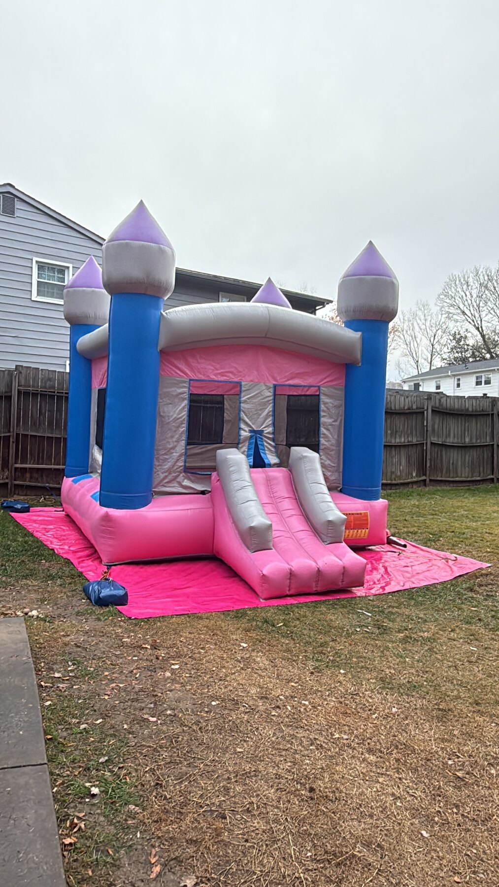 Supplier video of the pink castle bounce house setup.