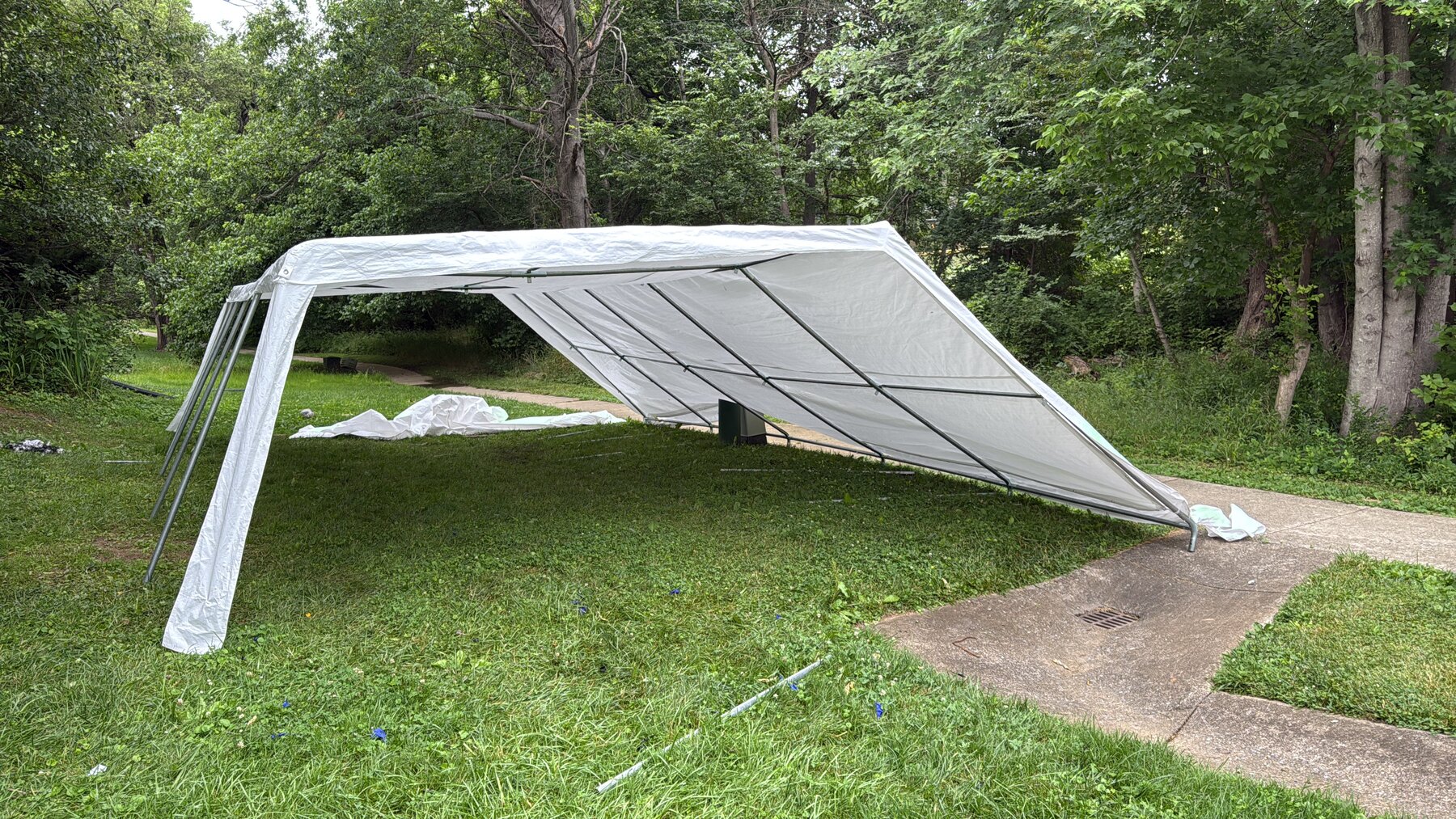 White event tent canopy on grass.